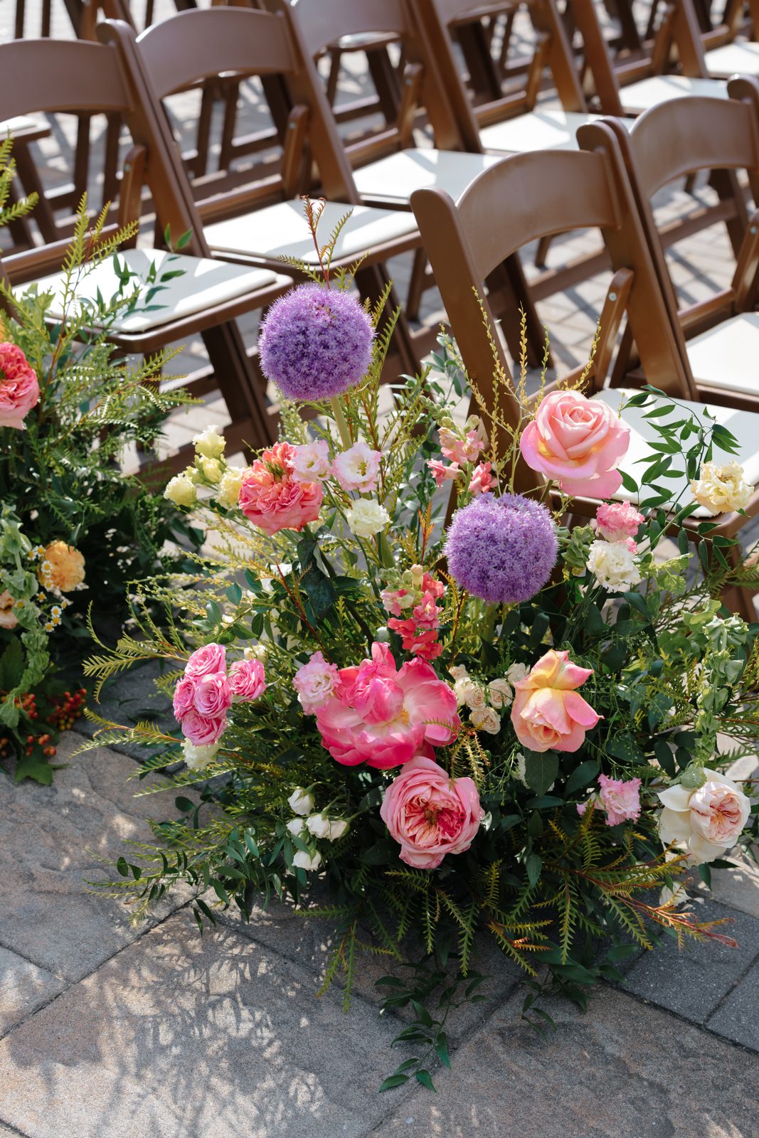 A detail from Dharma and Casey&rsquo;s colorful summer wedding at Bear Brook Valley