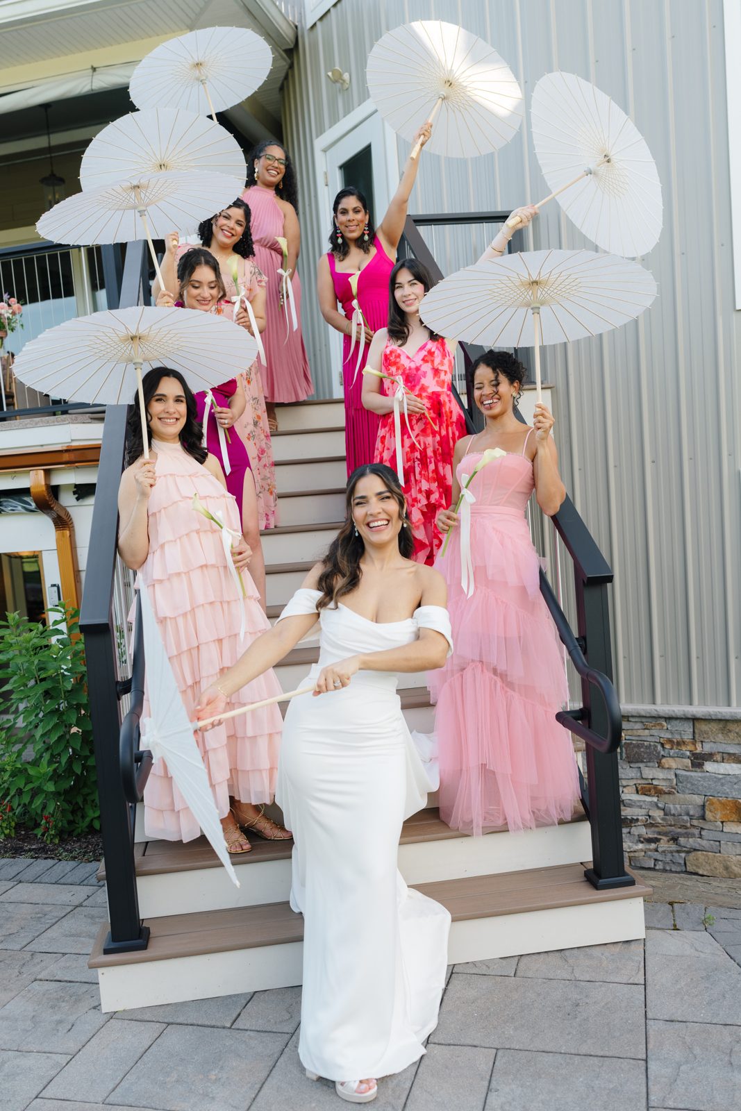 Dharma and her bridesmaids with parasols on the steps