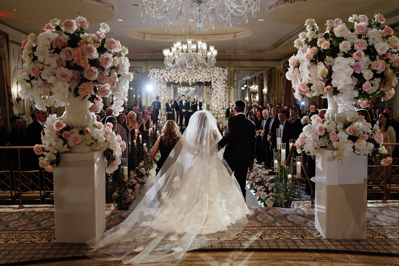 The rose chuppah and candlelit aisle in the Grand Ballroom of The Pierre