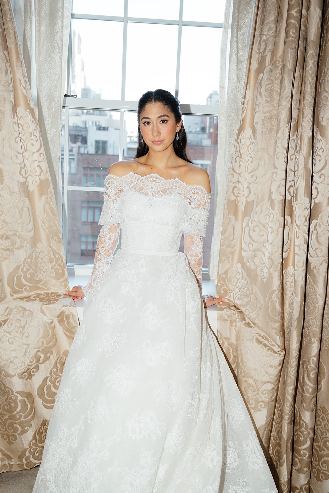 Dori at the window above Fifth Avenue in her wedding gown