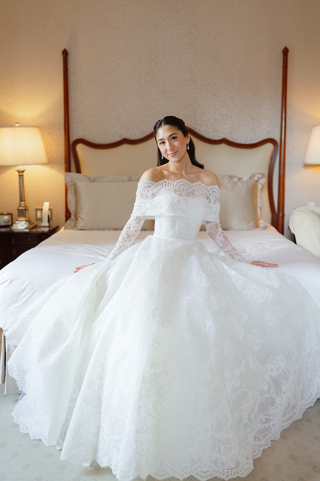 Dori seated in her lace off-the-shoulder gown