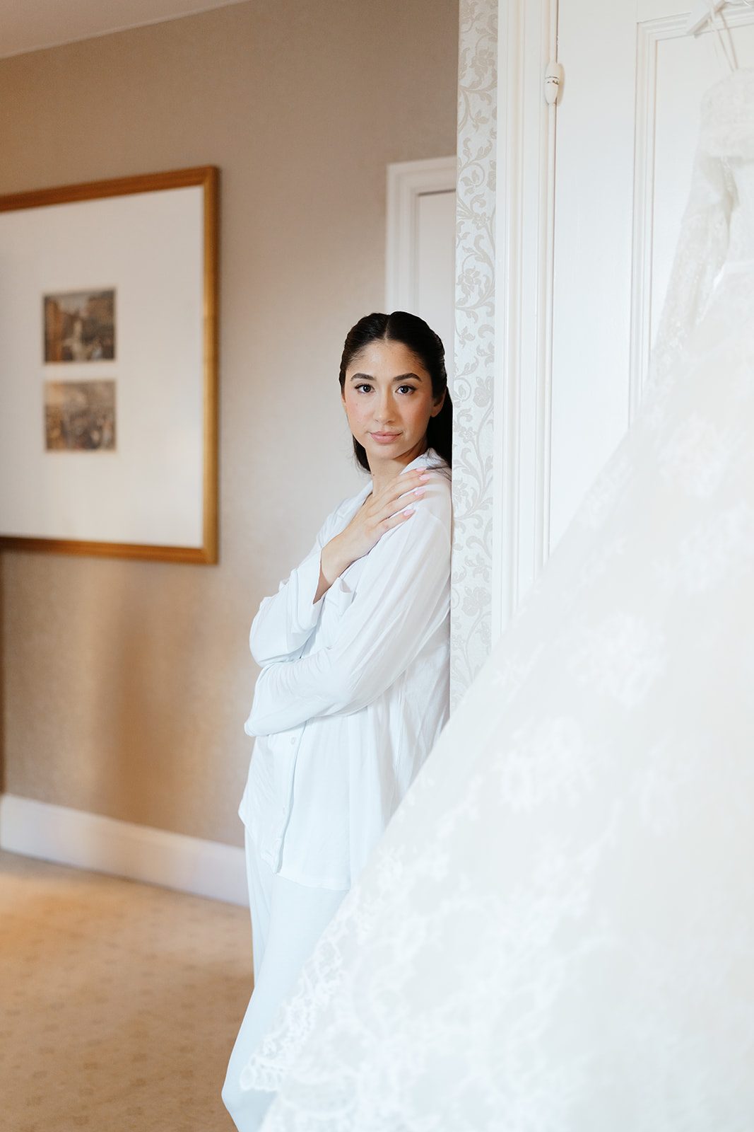 Dori in her robe beside her wedding gown at The Pierre