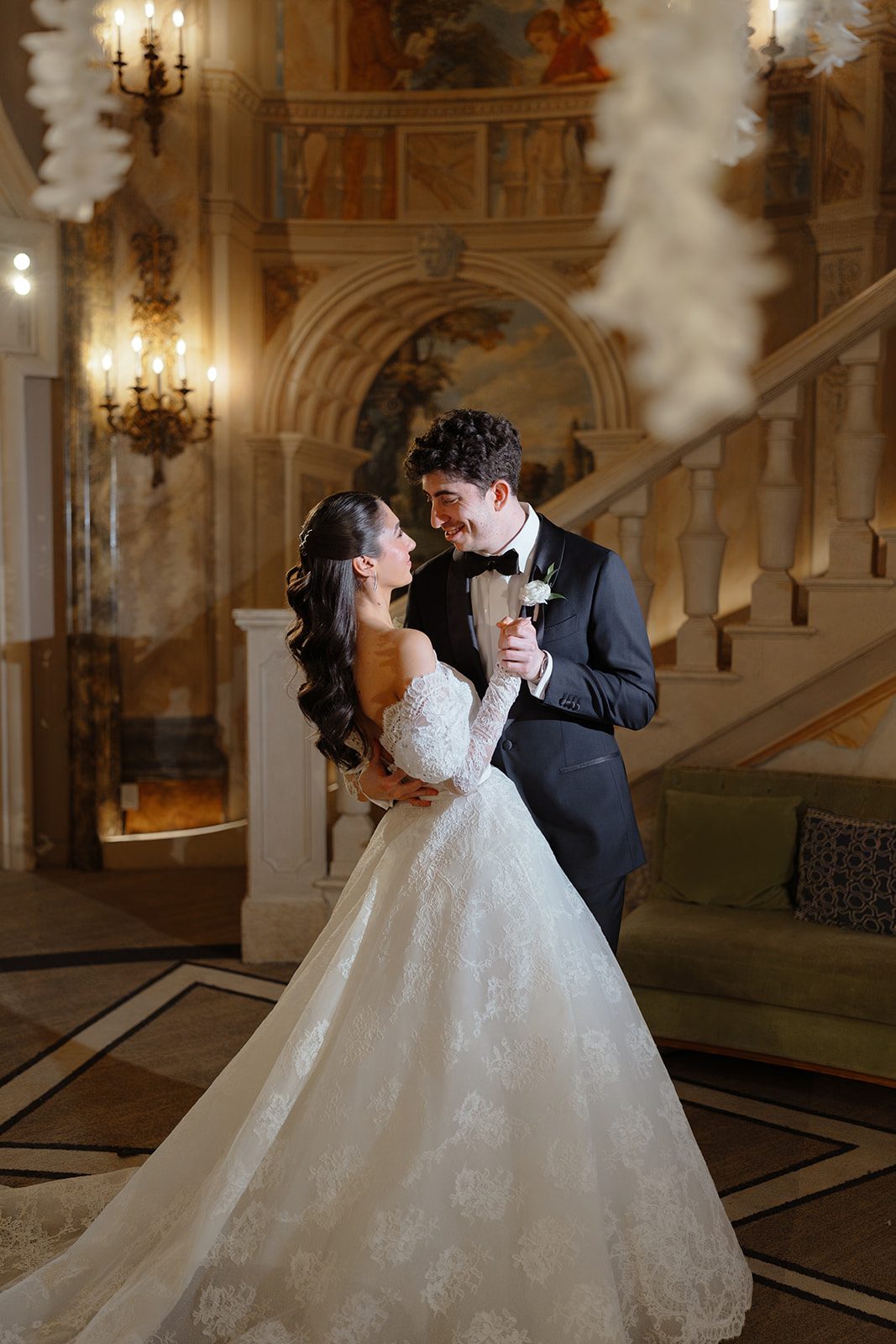 Dori and Ben embrace in a gilded hall at The Pierre