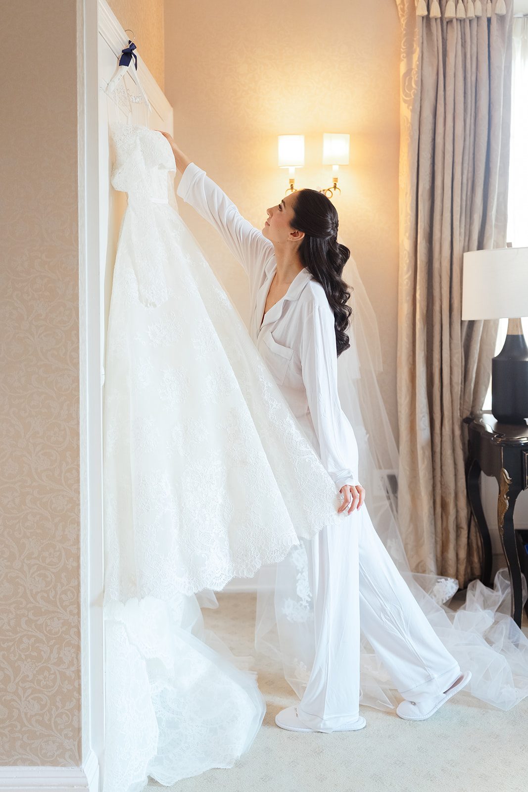 Dori reaching for her veil in the bridal suite