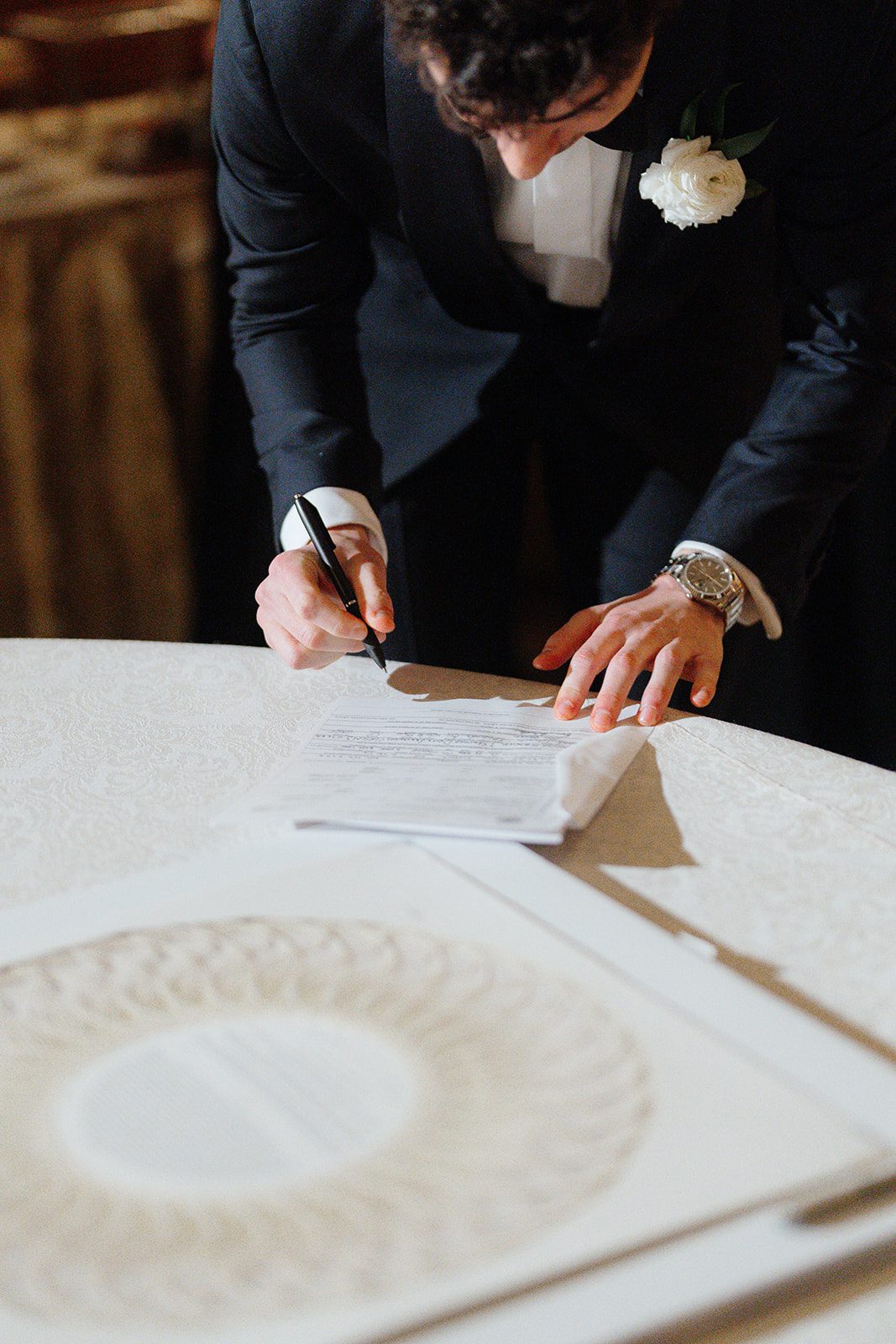 Ben signing the ketubah at The Pierre