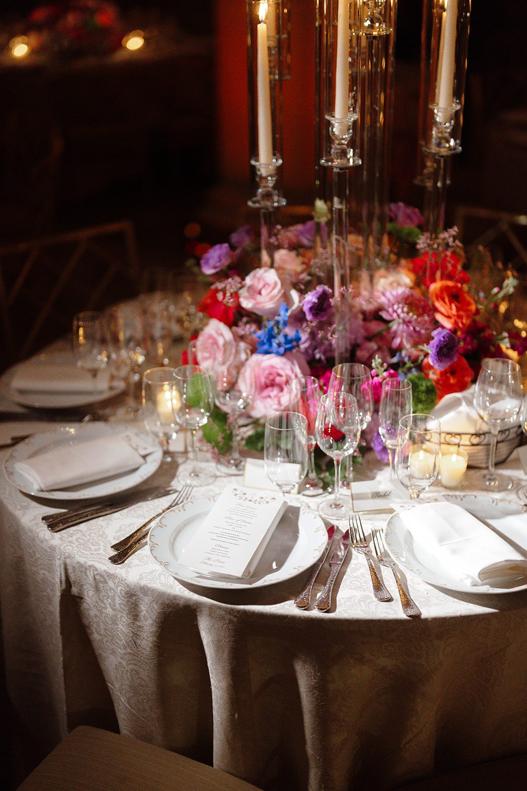 A centerpiece of roses and candlelight at the reception