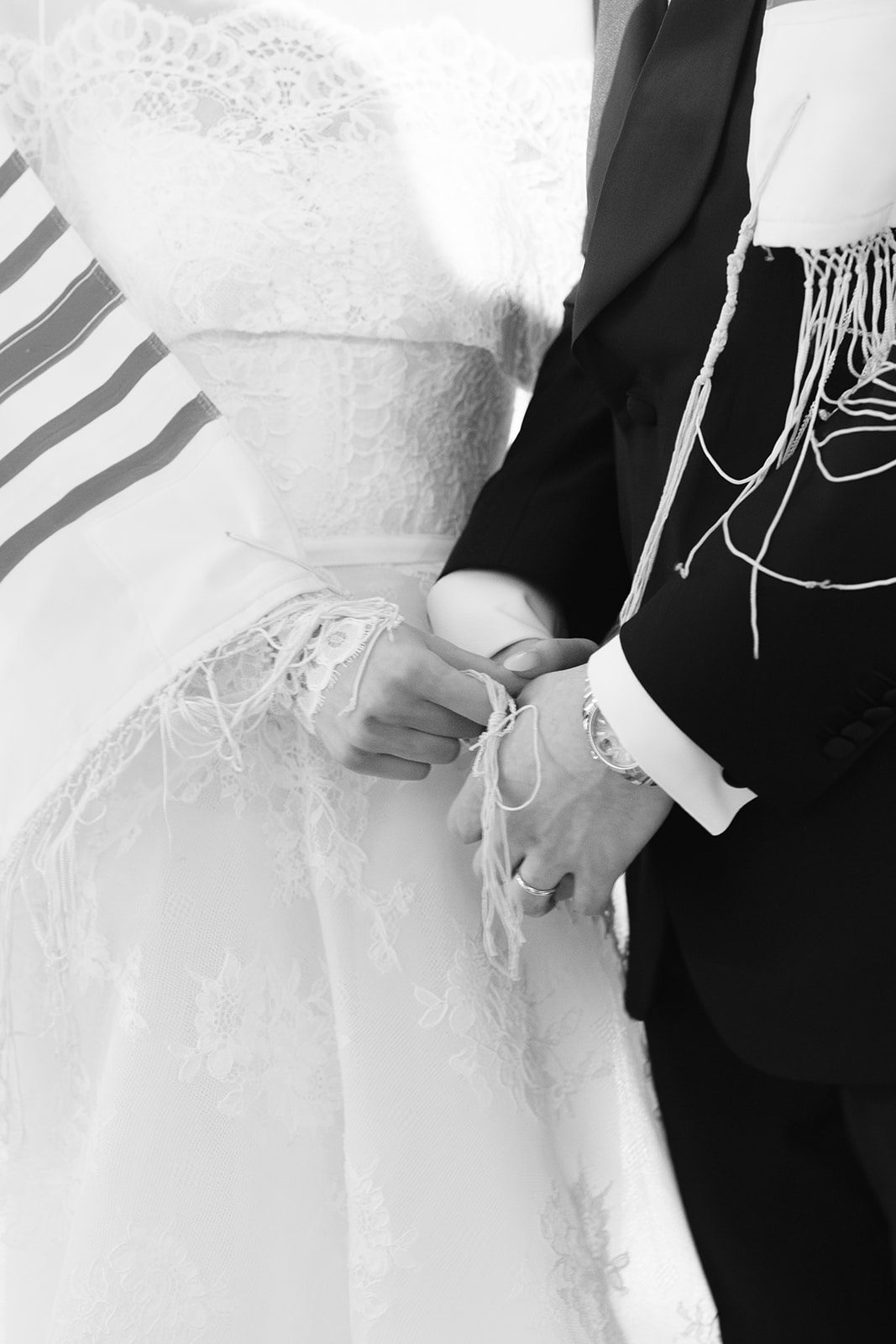 Hands and tallit during the ceremony, black and white