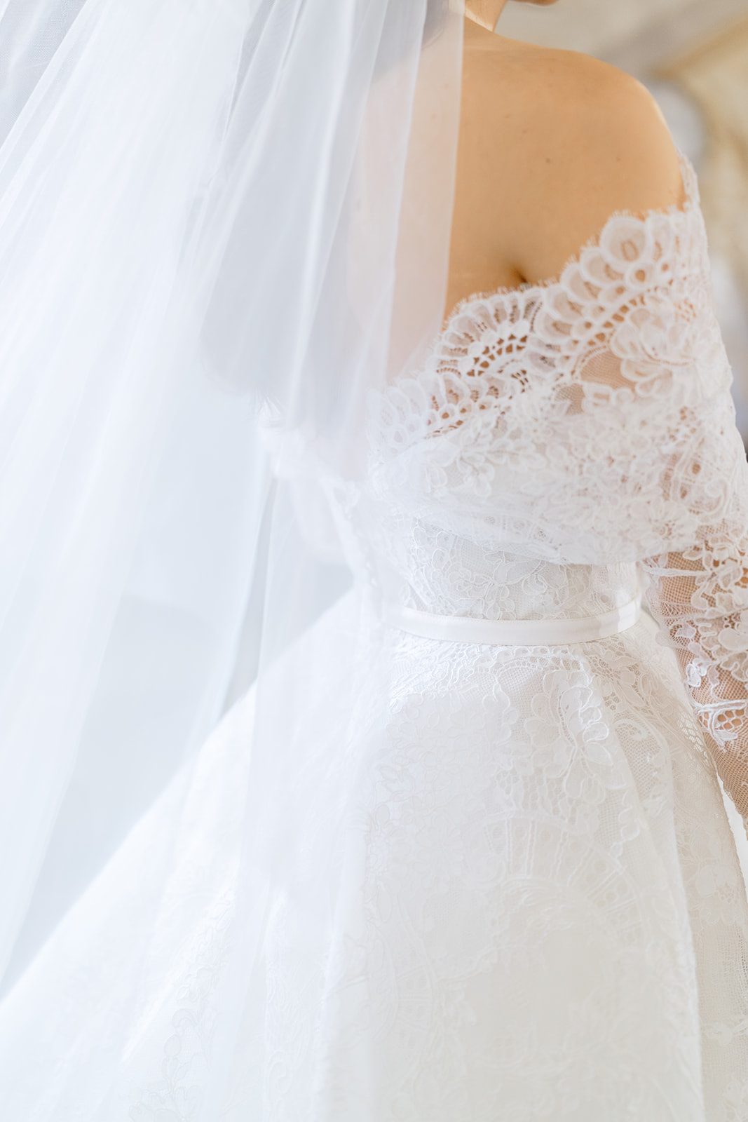 A detail of Dori&rsquo;s veil and lace sleeves