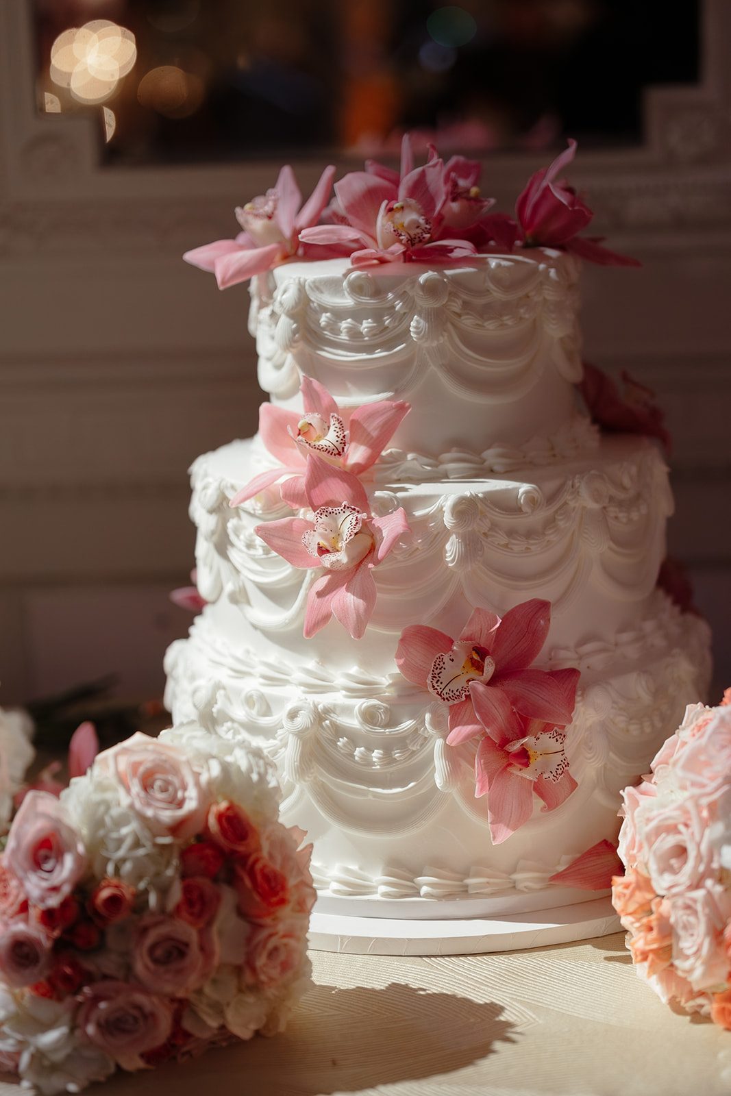 The wedding cake dressed in pink orchids