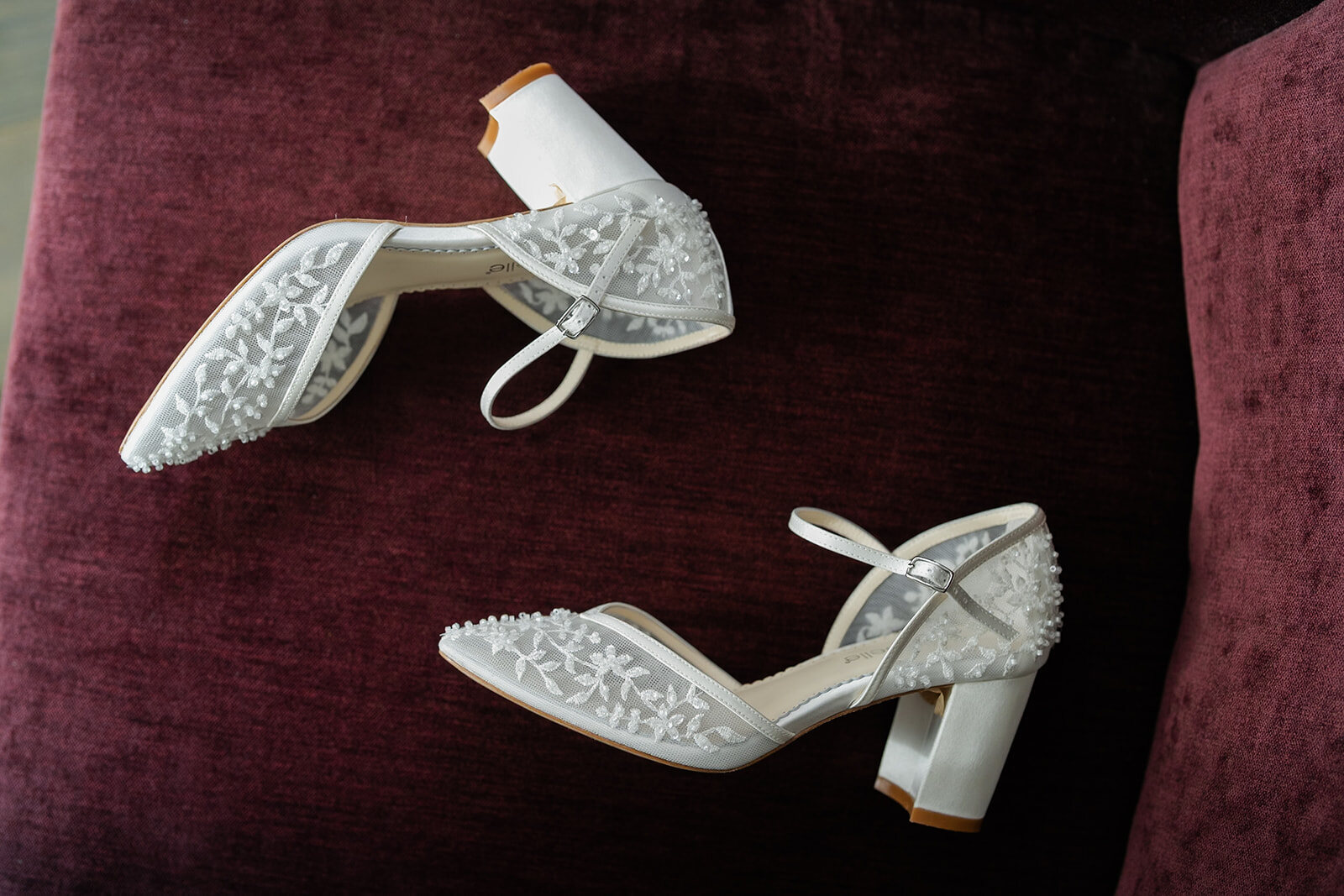 Ellie’s embellished bridal heels on burgundy velvet