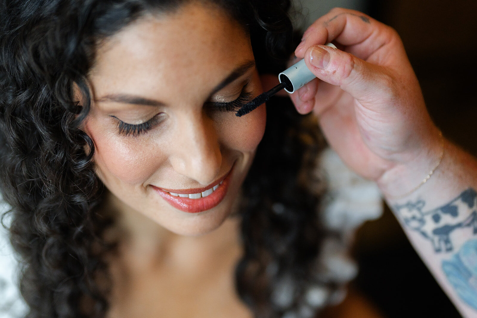 A close-up of Ellie’s makeup going on