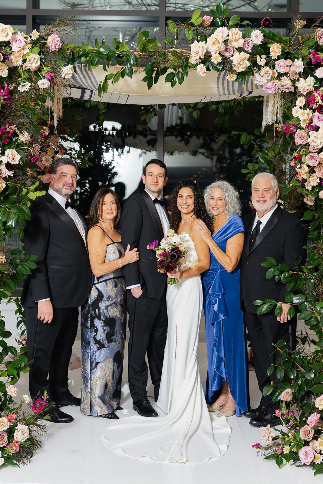 The family together under the floral chuppah