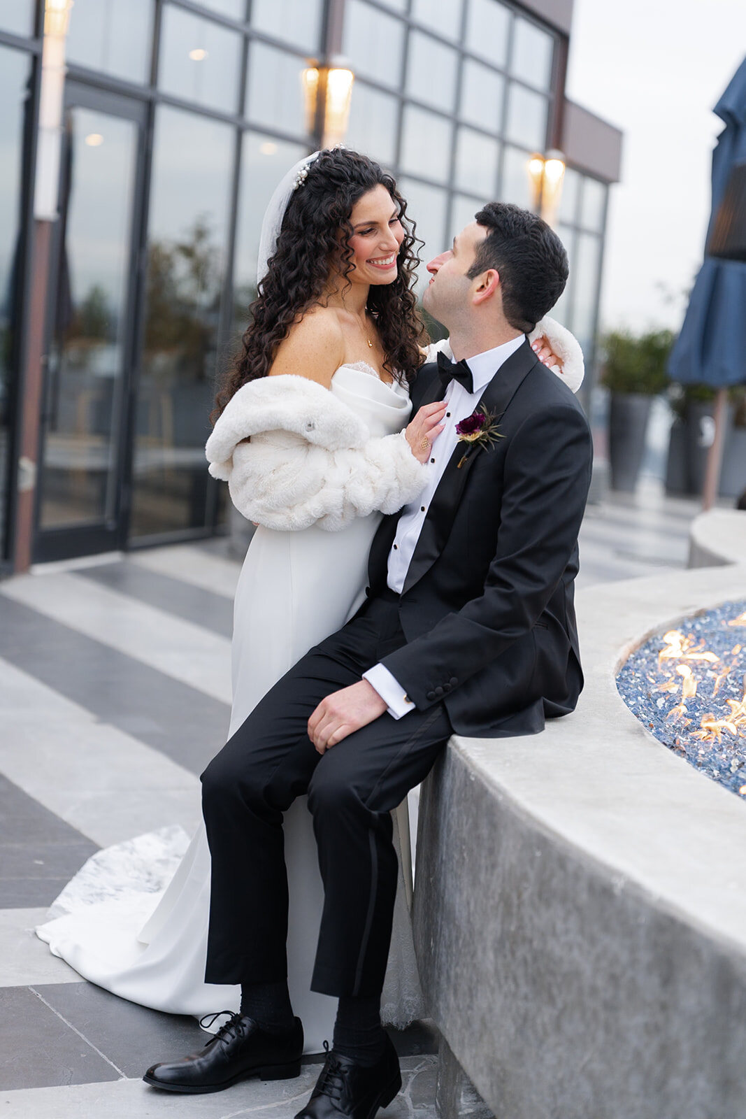 Ellie in a faux fur stole with Harrison on the terrace