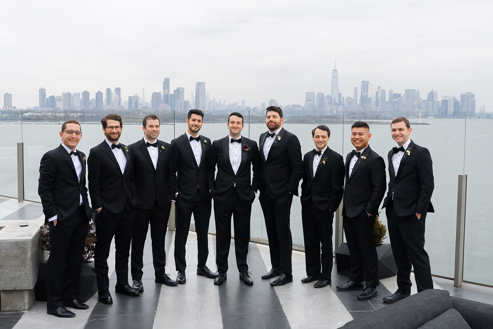 Harrison and his groomsmen on the Hudson House terrace with the Manhattan skyline behind them