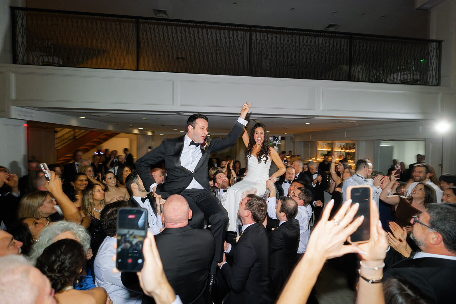 Ellie and Harrison lifted in chairs during the hora