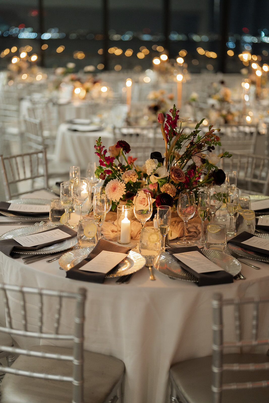 Reception tables with candlelight and pink florals