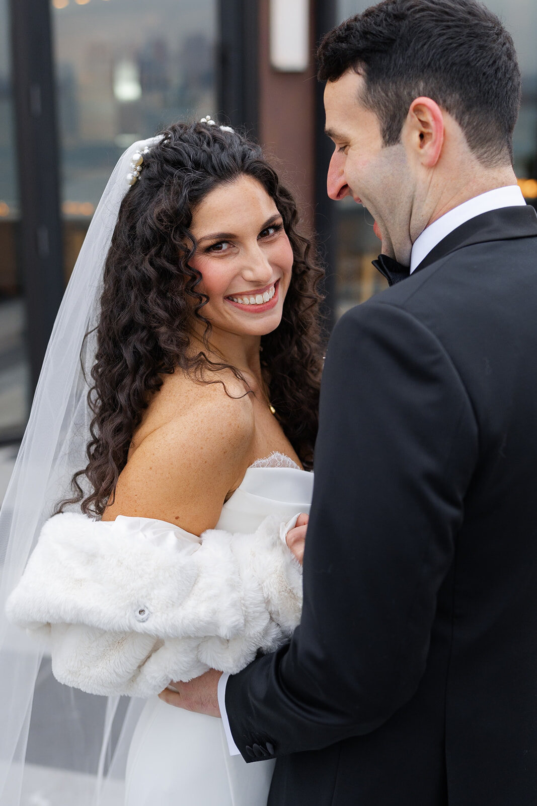 Ellie smiles up at Harrison in her veil