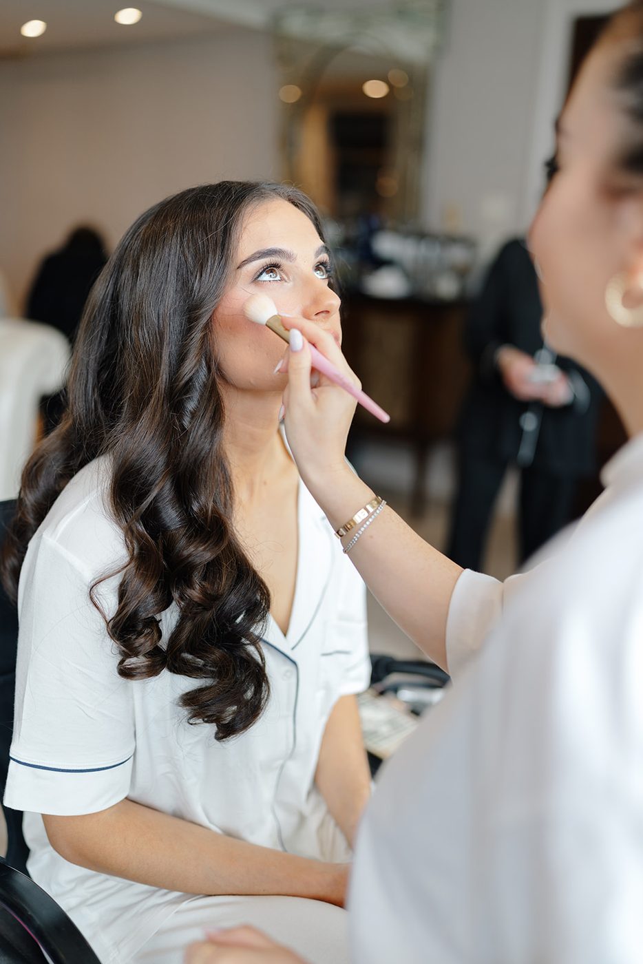 The bride has her makeup finished in the Paradise Suite on the morning of the wedding.