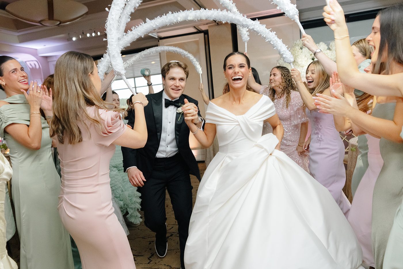 Bridesmaids cheer and dance around the seated bride during the kabbalat panim.