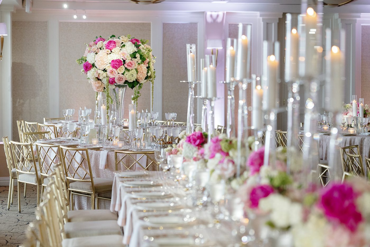 The reception tables set with tall crystal candelabras and pink and white florals.