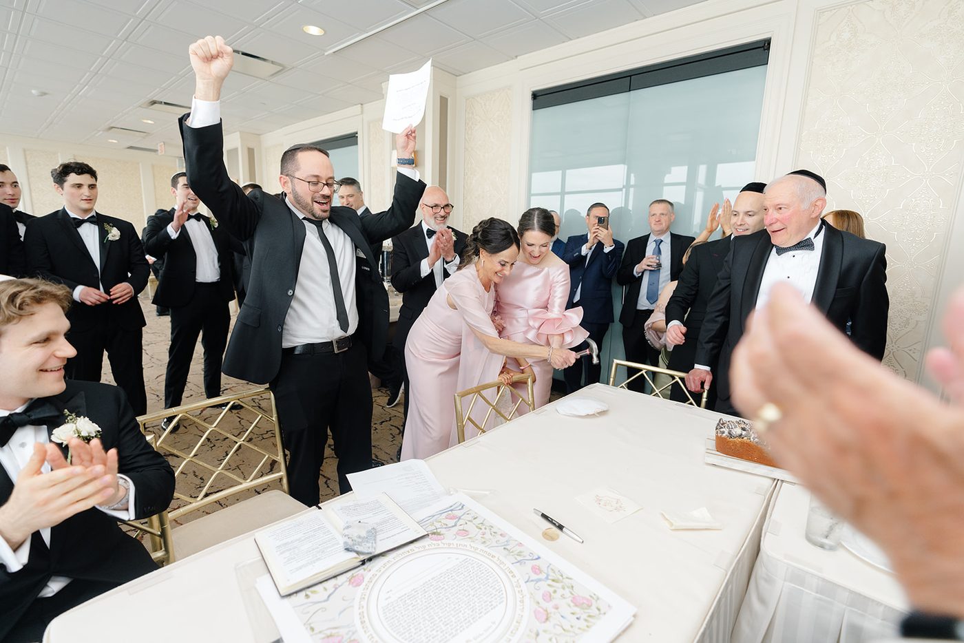 Men sing and celebrate around the groom at the tisch before the bedeken.