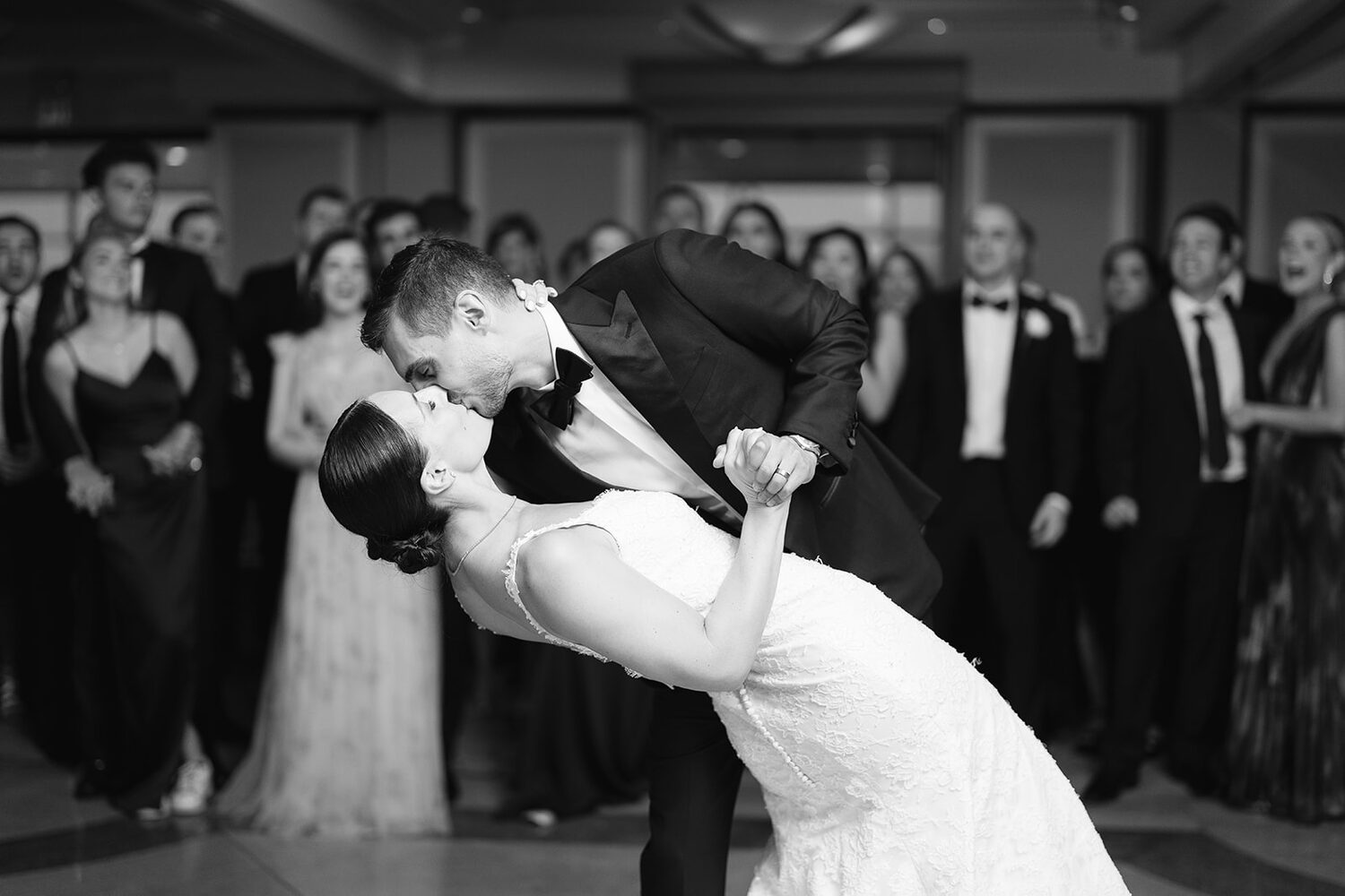 A dramatic black and white dip kiss in the middle of the reception.