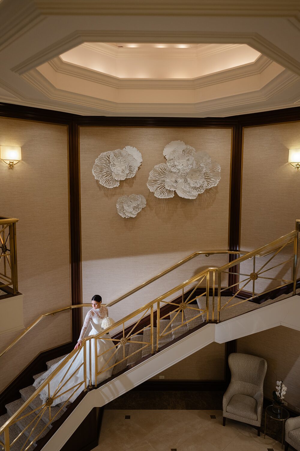 The bride descends the grand staircase beneath the rotunda dome, gown trailing behind her.