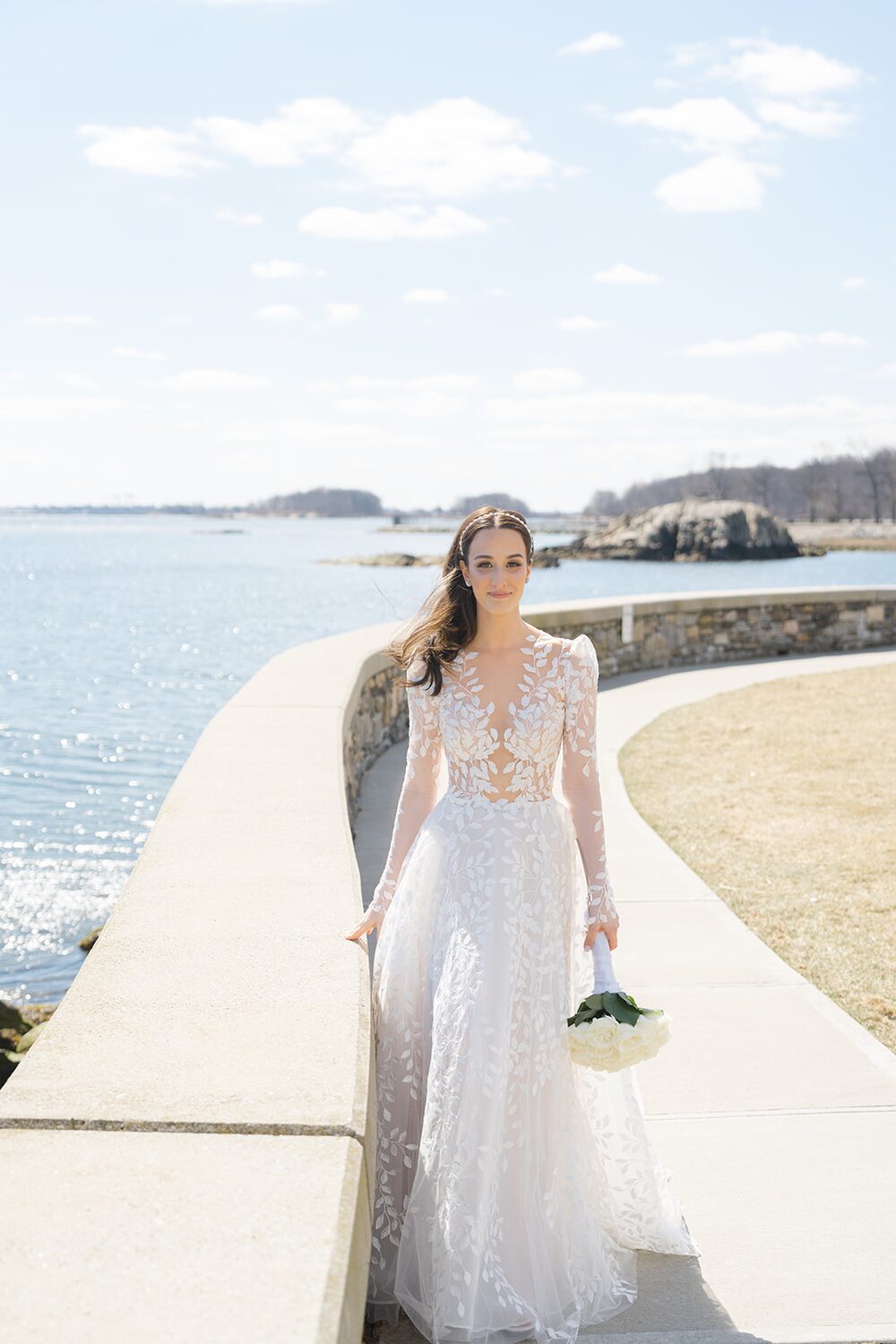 Bouquet in hand, the bride walks the seawall path along the Sound.