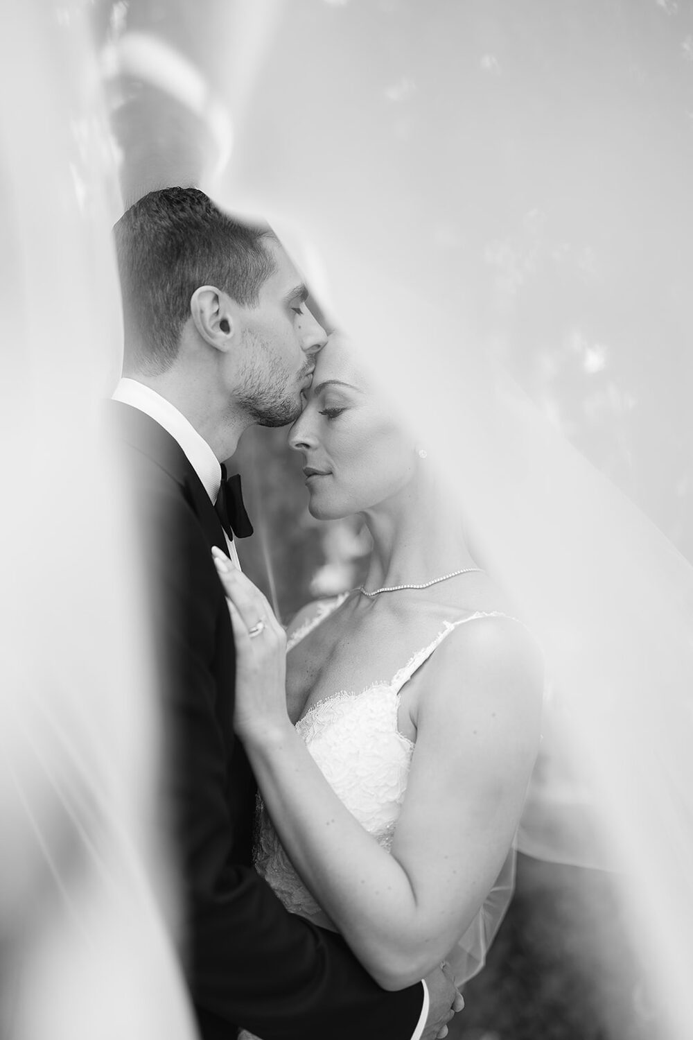 A dreamy portrait photographed through the bride's veil.