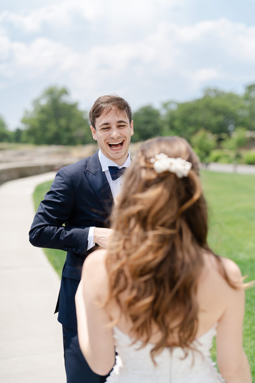 The groom's face lights up as he turns for the first look.
