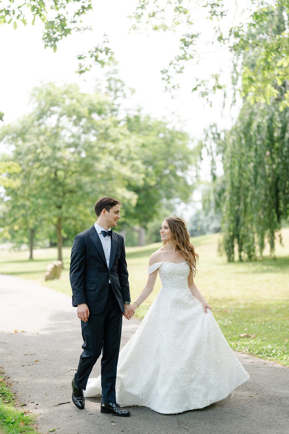 Hand in hand, the newlyweds-to-be stroll the park paths after their first look.