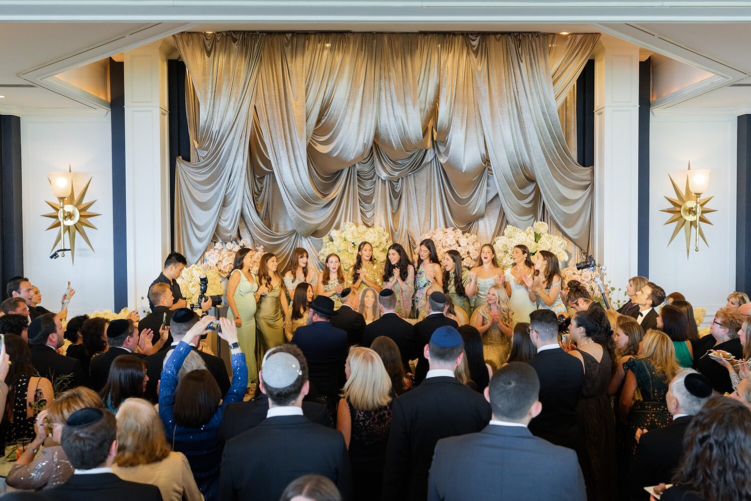 Guests fill the gold-draped room for the kabbalat panim.