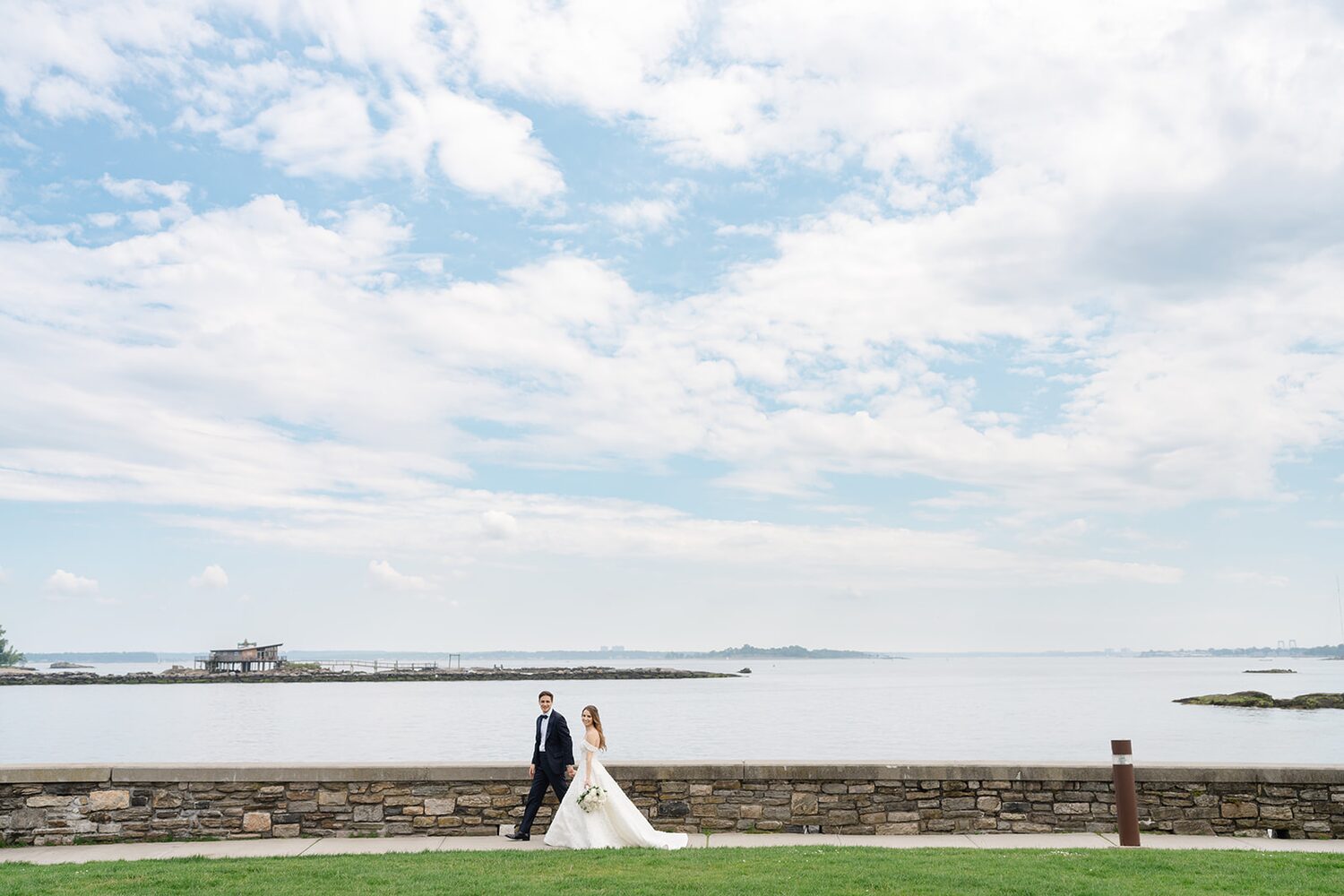 Walking the seawall under a towering summer sky on Long Island Sound.