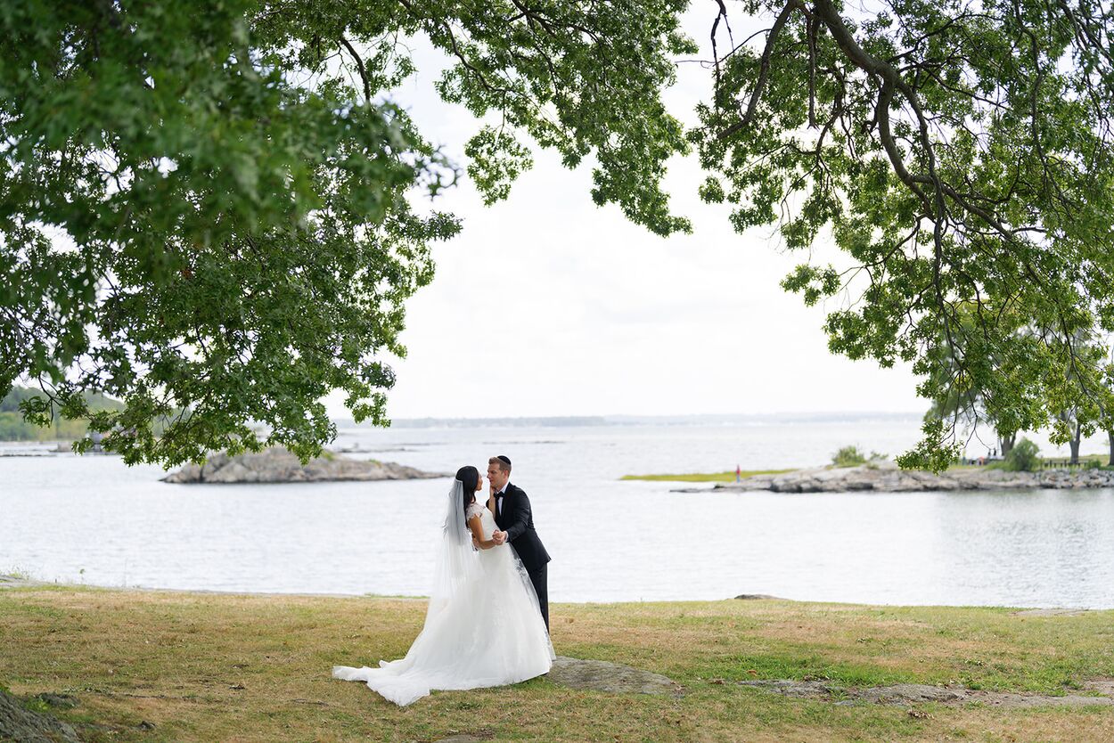 An August kiss on the shoreline lawn, a kayaker gliding past on the Sound.