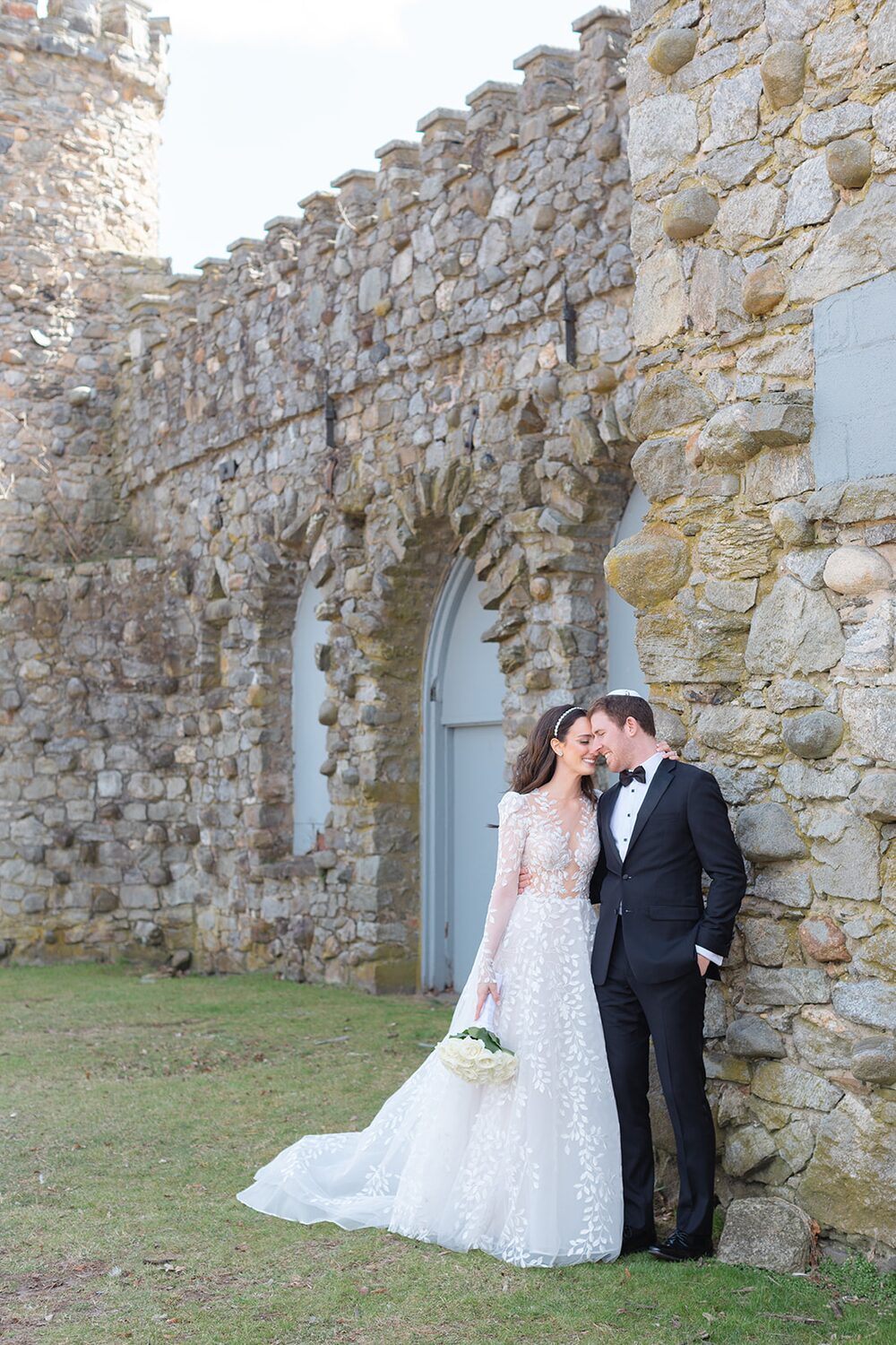 A kiss beside the historic stone castle structure on Glen Island.