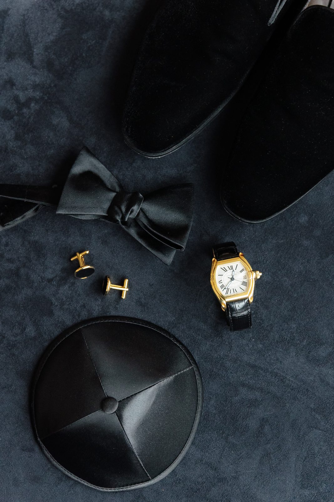 David's black kippah, bow tie, cufflinks and watch before the wedding
