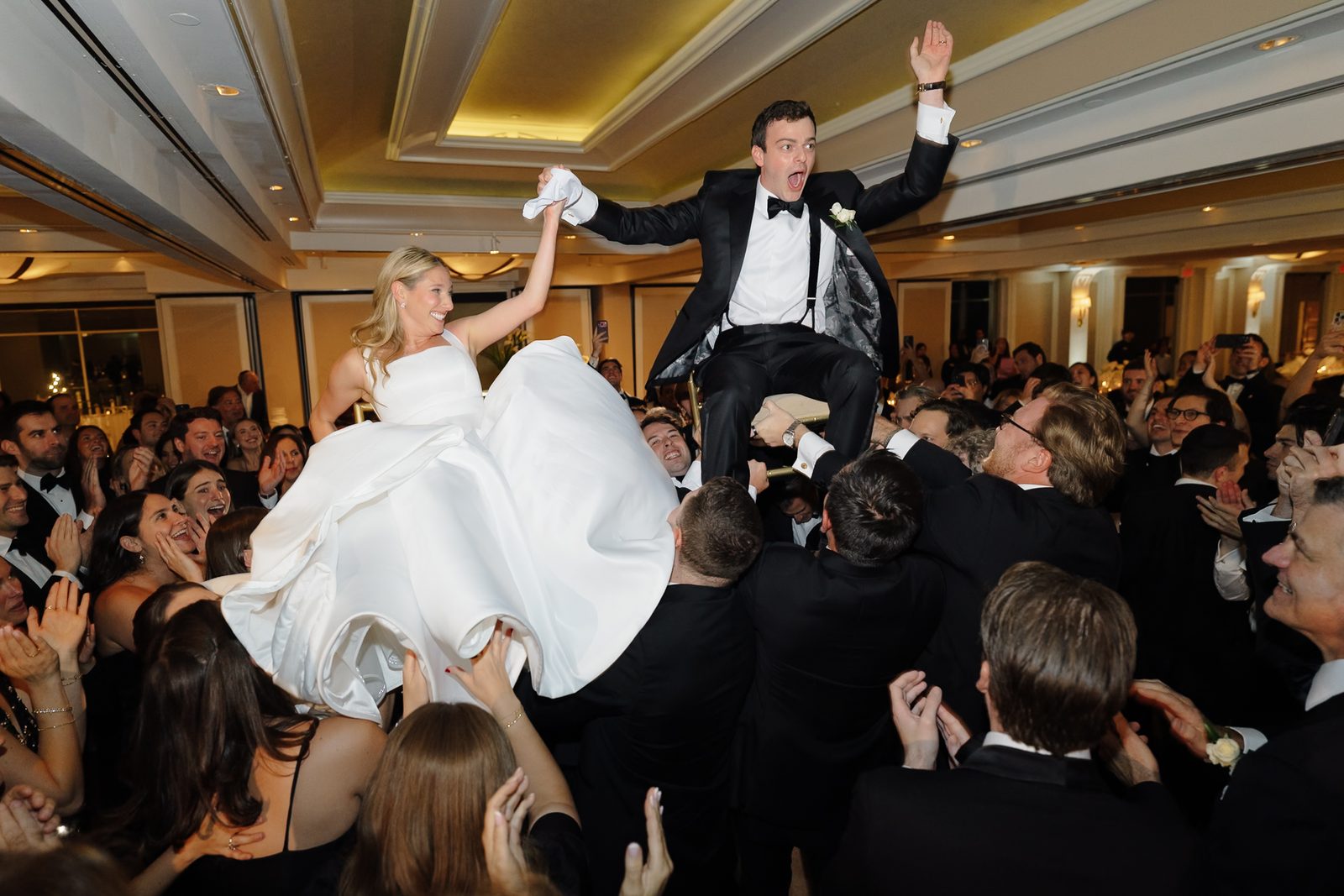 Hana and David lifted on chairs during the hora