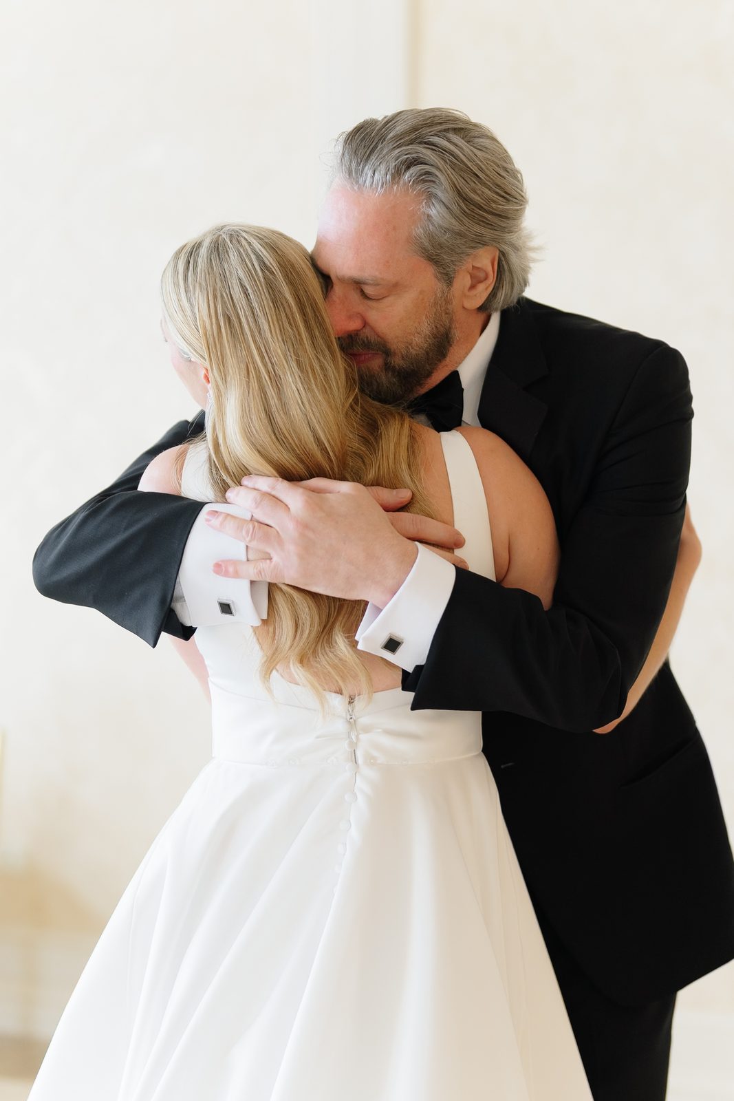 Hana and her father embracing at their first look