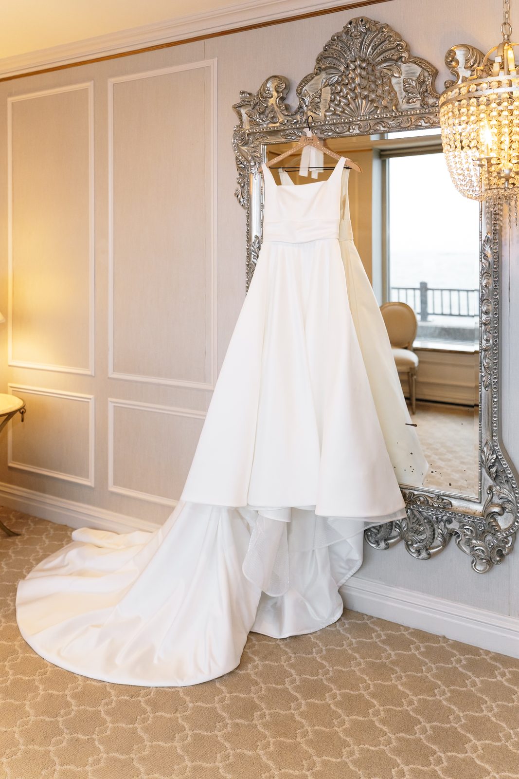 Rita Vinieris wedding gown hanging in the bridal suite at Glen Island Harbour Club