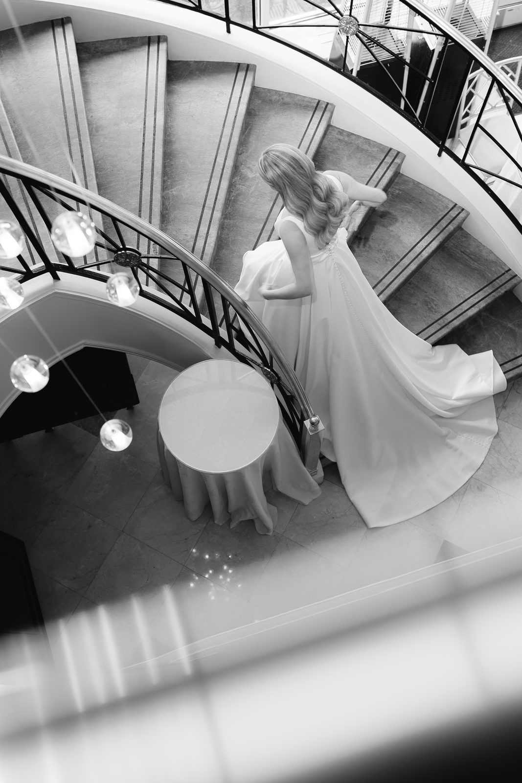 Black and white view down the spiral staircase at Glen Island Harbour Club with Hana and her train