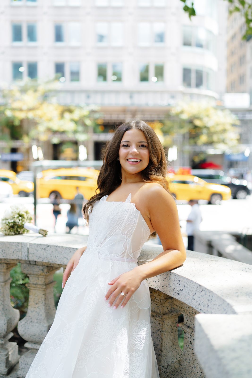 Jessie on the New York Public Library balustrade with Fifth Avenue traffic behind her