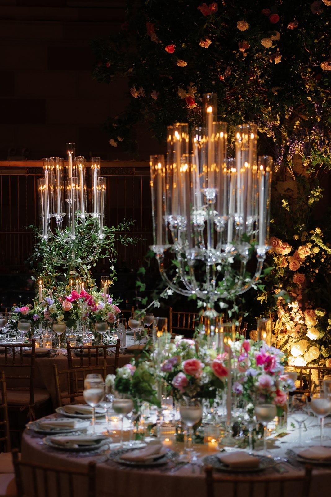 A candlelit centerpiece with blue and blush florals at the Gotham Hall reception