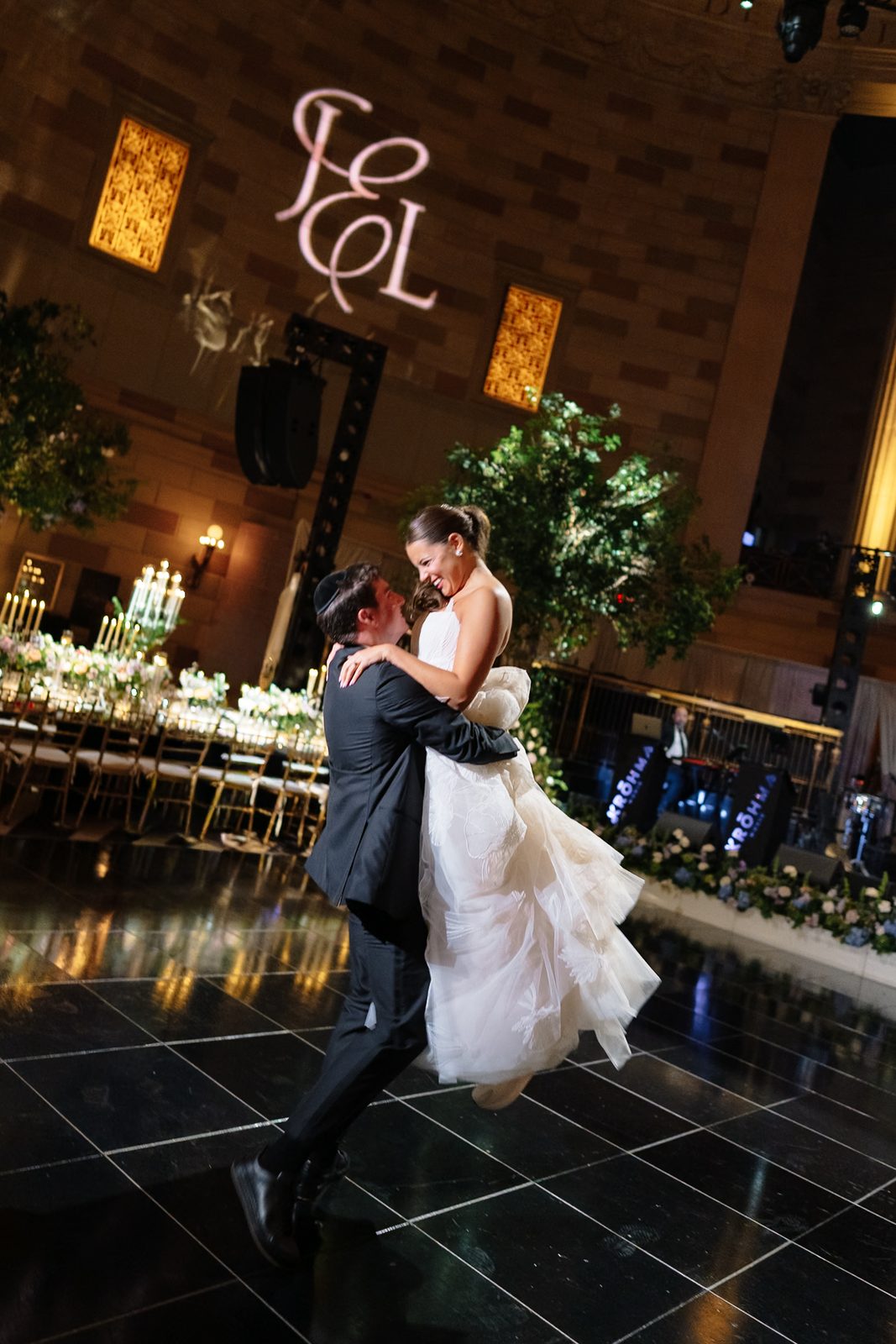 Linus carrying Jessie across the Gotham Hall ballroom at the end of the night