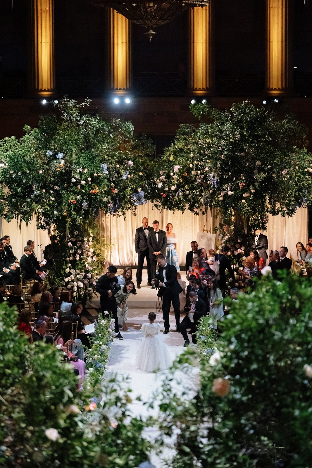 Jessie and Linus under a floral chuppah during their Jewish wedding ceremony at Gotham Hall