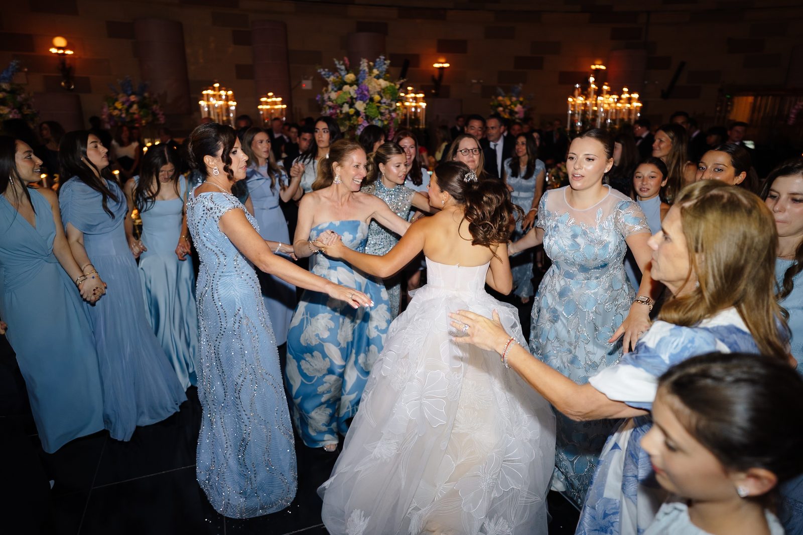 Jessie dancing with her bridesmaids in blue at the Gotham Hall reception