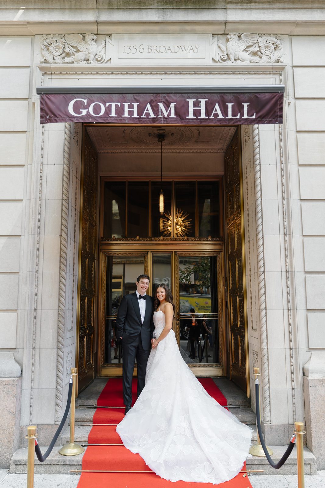 Jessie and Linus in the doorway of Gotham Hall at 1356 Broadway, under the venue's marquee