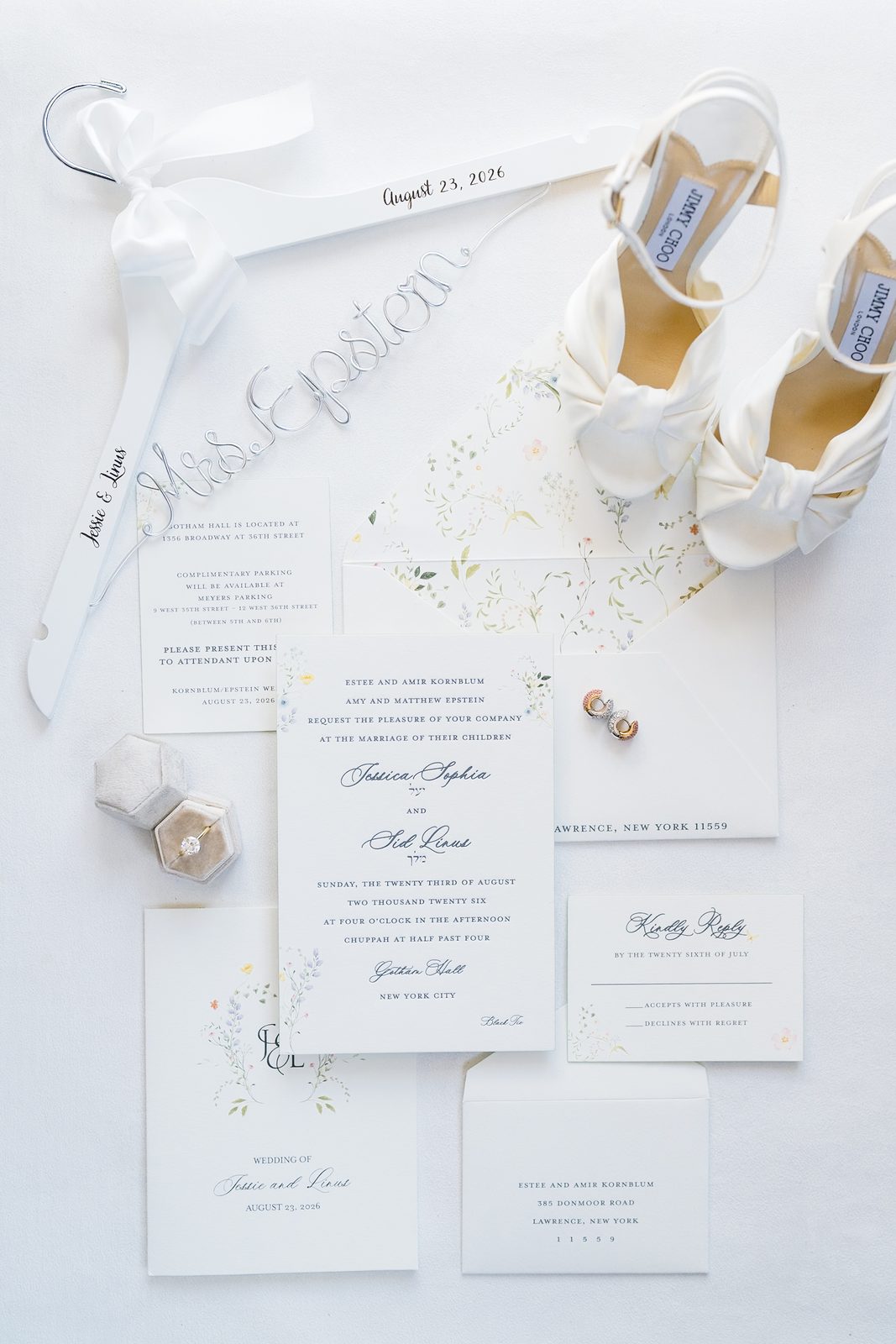 Jessie and Linus's invitation suite photographed with the rings and her shoes