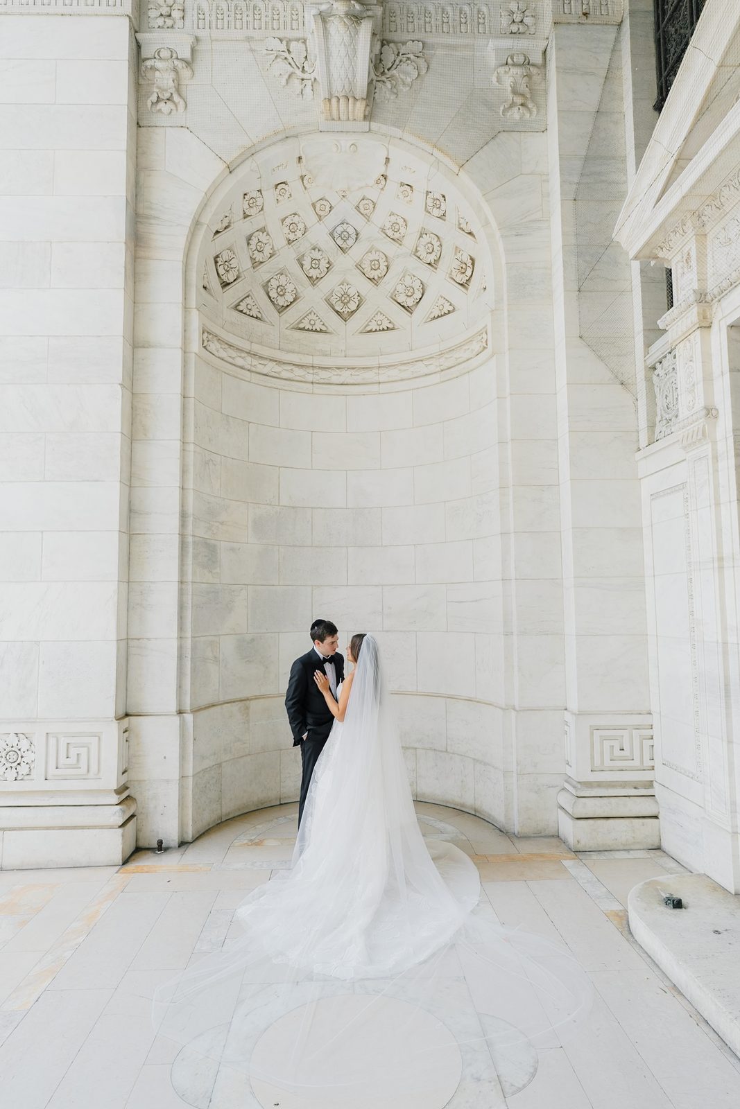 Jessie in a carved stone alcove at the New York Public Library