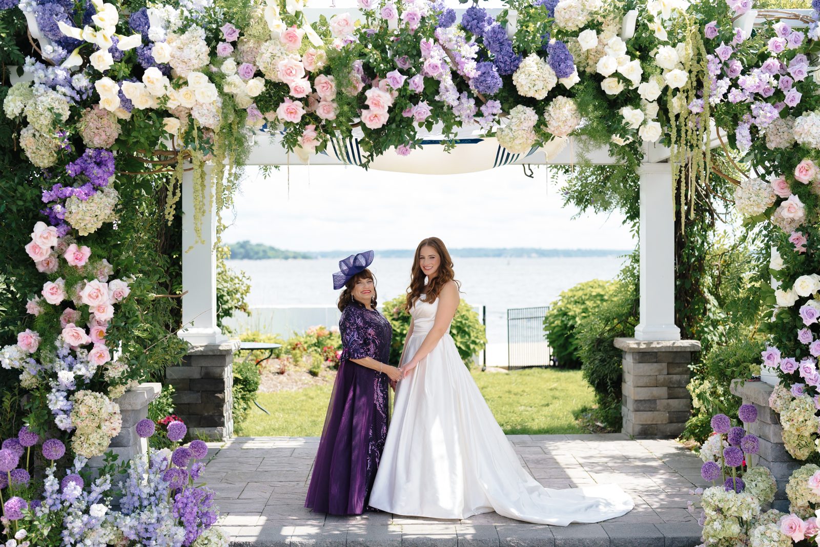 Bridesmaids in purple at the Greentree Country Club chuppah