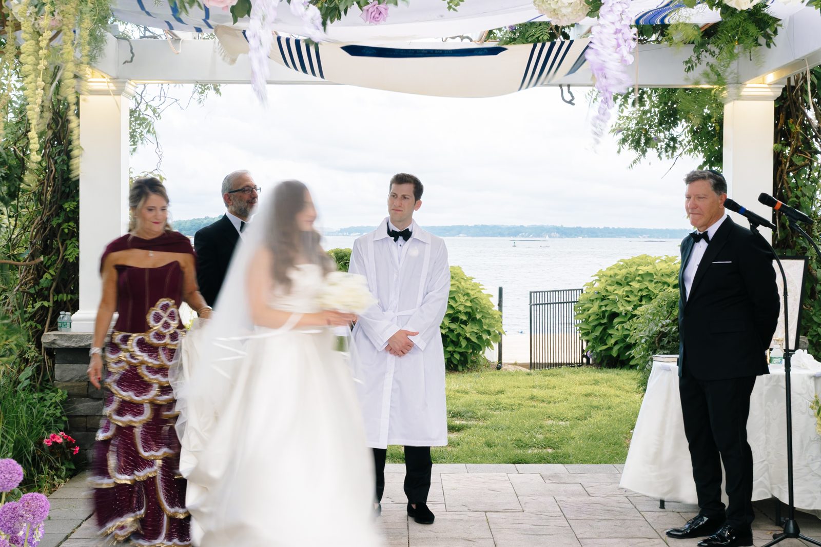 The chuppah from behind, water beyond
